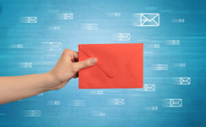 Hand holding envelope with message symbols around